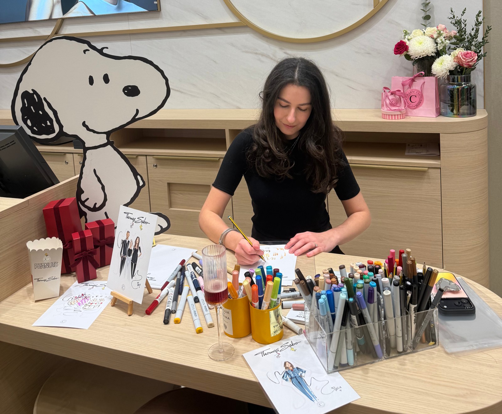 Daria drawing guest portraits at a live event